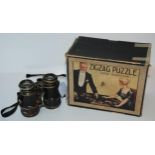 A vintage Zigzag Puzzle in original box and a pair of vintage field glasses (2) Condition Report: