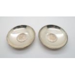 A pair of Austrian silver dishes, of circular form inset with Maria Theresa Thaler coins, stamped