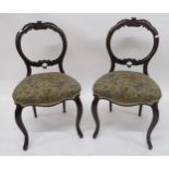A set of six Victorian rosewood balloon back dining chairs with floral upholstery (6) Condition