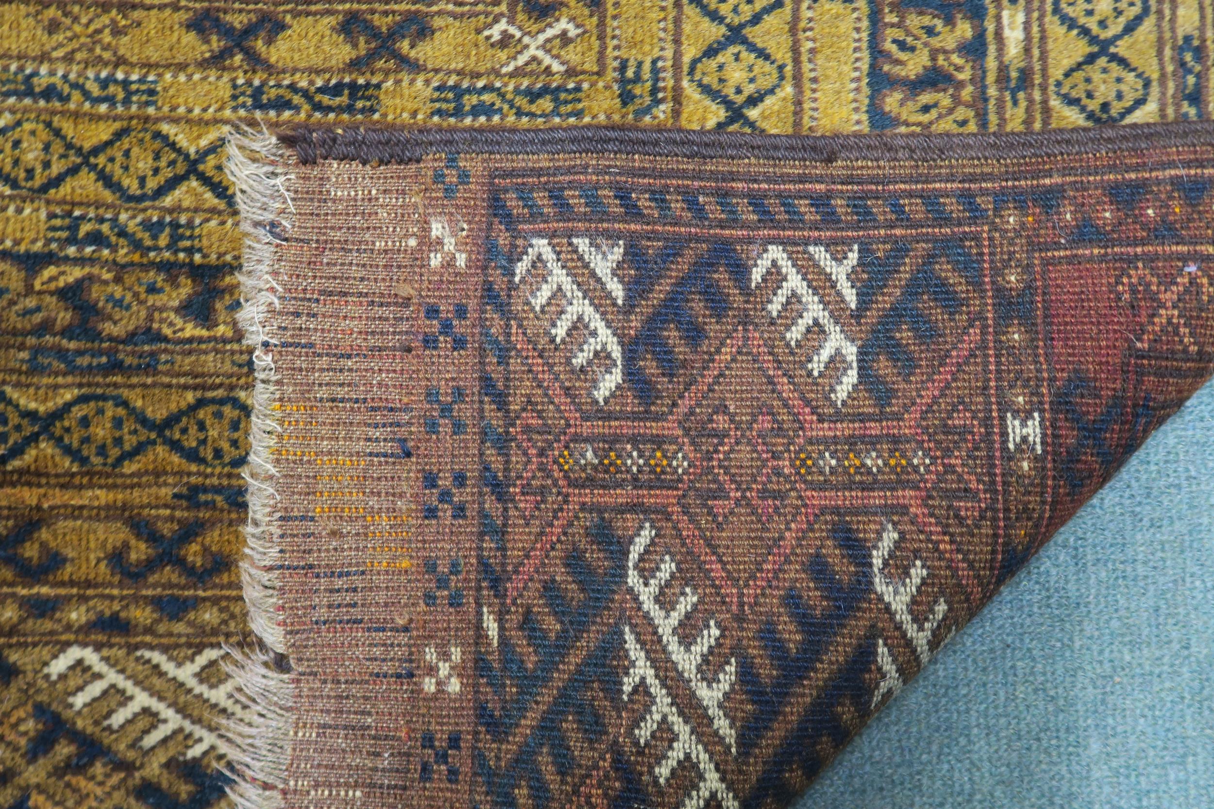 A mustard ground Bokhara rug with multiple borders, 211cm long x 138cm wide Condition Report: - Image 4 of 4