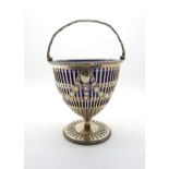 A Victorian silver sugar basket with cast floral handle, the body pierced with decoration of