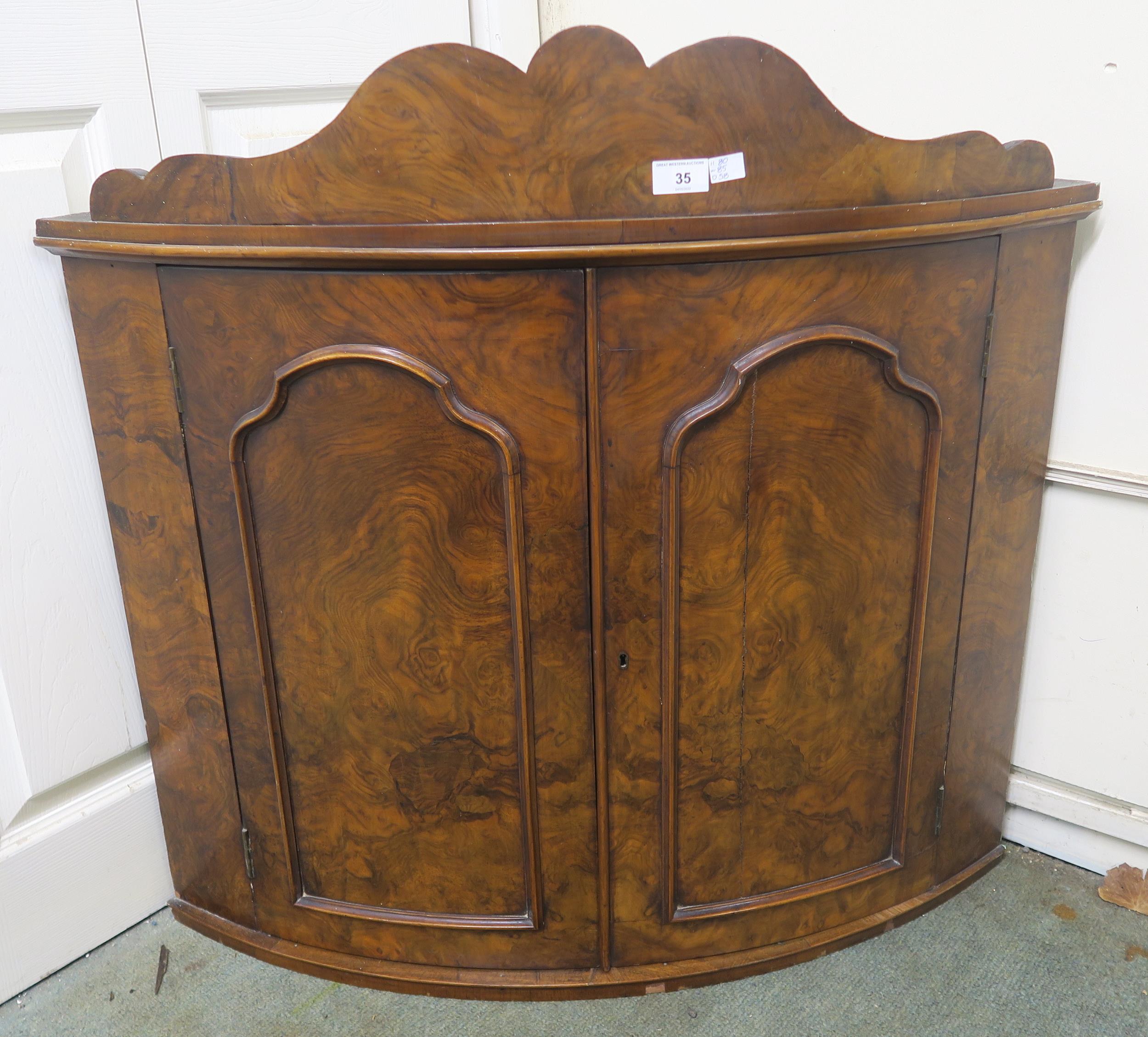 A Victorian walnut two door hanging corner cabinet and an upholstered armchair (2) Condition