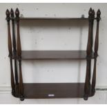 A Victorian mahogany three tier wall shelf and two upholstered footstools (3) Condition Report: