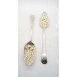 A pair of George III silver Old English pattern berry spoons, with engraved scrolling terminals,