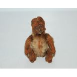 A Schuco compact, in the form of a monkey, the body opening to reveal a mirror and a powder section,