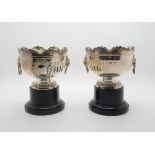 A pair of silver urns, the bodies fluted with blank cartouches and lion mask drop ring handles,