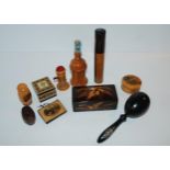 A collection of Mauchline ware including pin cushion, novelty tape measure, needle case etc