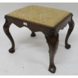 An early 20th century mahogany footstool with gilt upholstered drop in pad on shaped cabriole