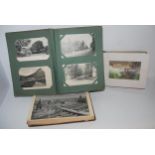 An album of colour and black and white topographical postcards, album of drawing and an album of