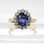 An 18ct gold blue gem and diamond ring, size N, weight 5.6gms Condition Report:Available upon