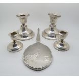 A pair of silver dwarf candlesticks (weighted), each flaring scone on spreading circular base, by