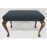 An early 20th century mahogany framed footstool upholstered in a contemporary wool fabric on