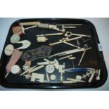 A tray lot of various early 20th century ivory pieces including bobbins, needle case, miniature