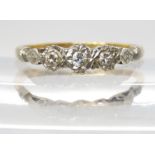 A 1950's 18ct gold and platinum three stone diamond ring, inner shank inscribed 1955, set with