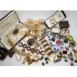 A collection of costume jewellery to include a retro necklace, whale brooch, badges etc Condition
