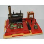 A Mamod steam engine on later formica base, 36cm wide overall Condition Report:Available upon
