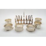 A collection of silver including a six division silver toast rack by Adie Brothers Ltd, Birmingham