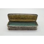 A Victorian silver ring box, of rectangular form with scrolling foliage decoration to sides and lid,