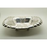 A stamped sterling dish, the body fluted, with engraved initials 'JDR' to centre, on four pumpkin