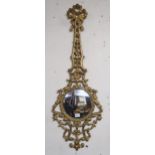 A 20th century brass framed rococo style dressing mirror and a similar painted cast metal wall