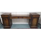 A Victorian mahogany pedestal sideboard with three concave central drawers flanked by cabinets