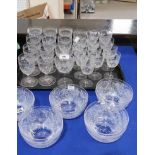 A part suite of drinking glasses and finger bowls, all with cut decoration of spiders webs,