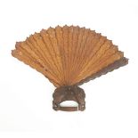 An Indian sandalwood fan, the handle carved with two birds, the sticks carved as feathers, the guard