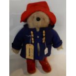 A Paddington Bear in blue duffel coat, red wellington boots and a red hat, design registration No.