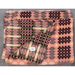 A Welsh blanket, the coral pink ground with black, white and yellow decoration Condition Report: