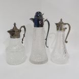 Three EPNS topped cut and moulded glass claret jugs, one with mask spouts (3) Condition Report: