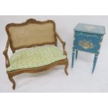 An early 20th century painted bedside locker, bergere love seat, carved spinning chair and a fall