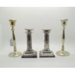 A pair of Edwardian silver candlesticks, the stepped square bases with scale motifs, supporting