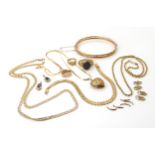 A collection of 9ct gold and yellow metal items to include a bangle, chains rings, pendants etc