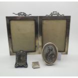 An Edwardian silver double photo frame decorated with ribbon swags, by E Mander & Son, Birmingham