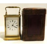 A French brass and glass carriage clock, with travelling case and key Condition Report:winds and