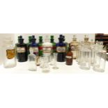 A collection of glass chemists bottles including five green examples, three blue and the remaining