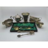 A collection of silver including a Georgian style silver sauce boat with flying scroll handle, by