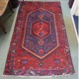 A dark blue ground Zanjan rug with red central medallion, 225cm long x 127cm wide Condition Report: