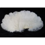 A GROUP OF EARLY 20TH CENTURY WHITE OSTRICH FEATHER FANS one mounted on celluloid sticks with