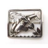 A silver Georg Jensen dolphins brooch, pattern number 251, with UK London import marks for 1964