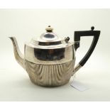 A Victorian silver teapot, of flattened form, the body fluted, with wooden handle and ivory