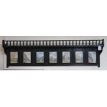 A Victorian ebonised wall shelf inset with seven watercolour panels Condition Report:Available