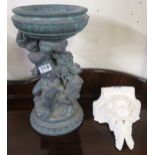 A contemporary small cast resin cherub holding up a birdbath and a plaster cherub wall sconce (2)