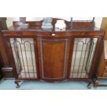 A 20th century mahogany glazed display cabinet with domed central door flanked by glazed doors on