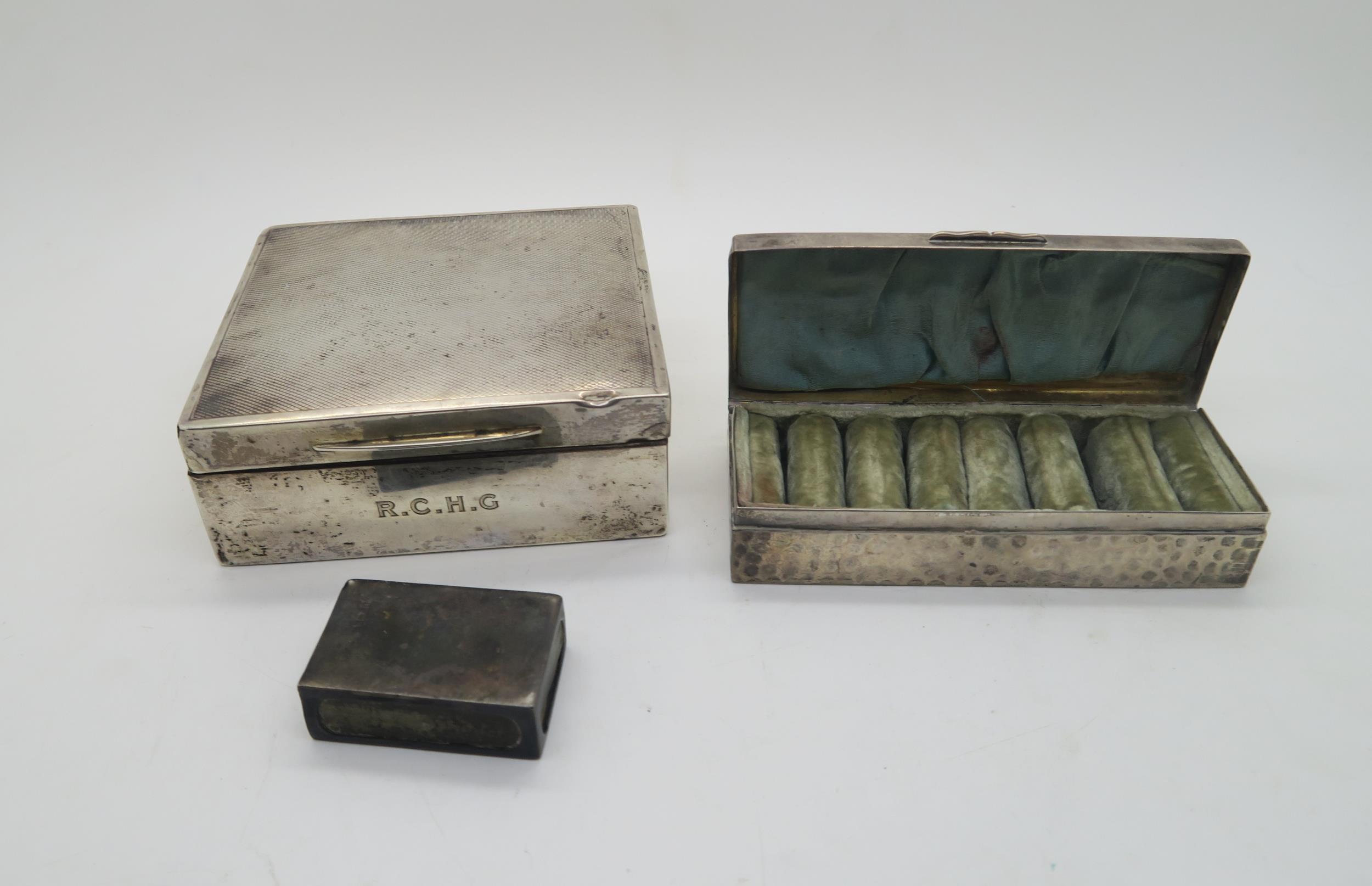 An Edwardian silver ring box, of rectangular form with hammered finish, a seven section velvet