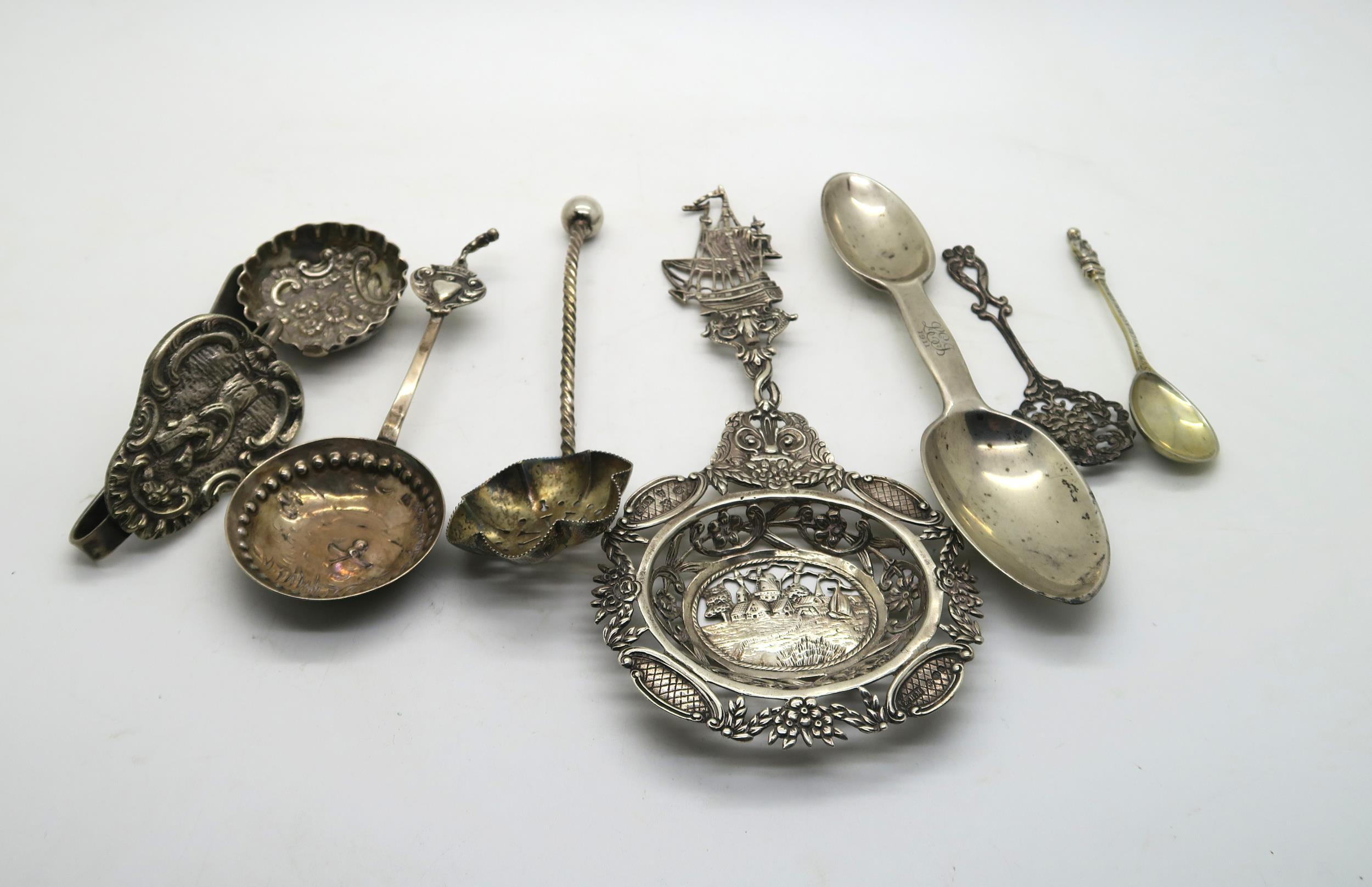 A collection of silver including a silver strainer spoon with pierced and engraved decoration of