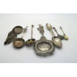 A collection of silver including a silver strainer spoon with pierced and engraved decoration of