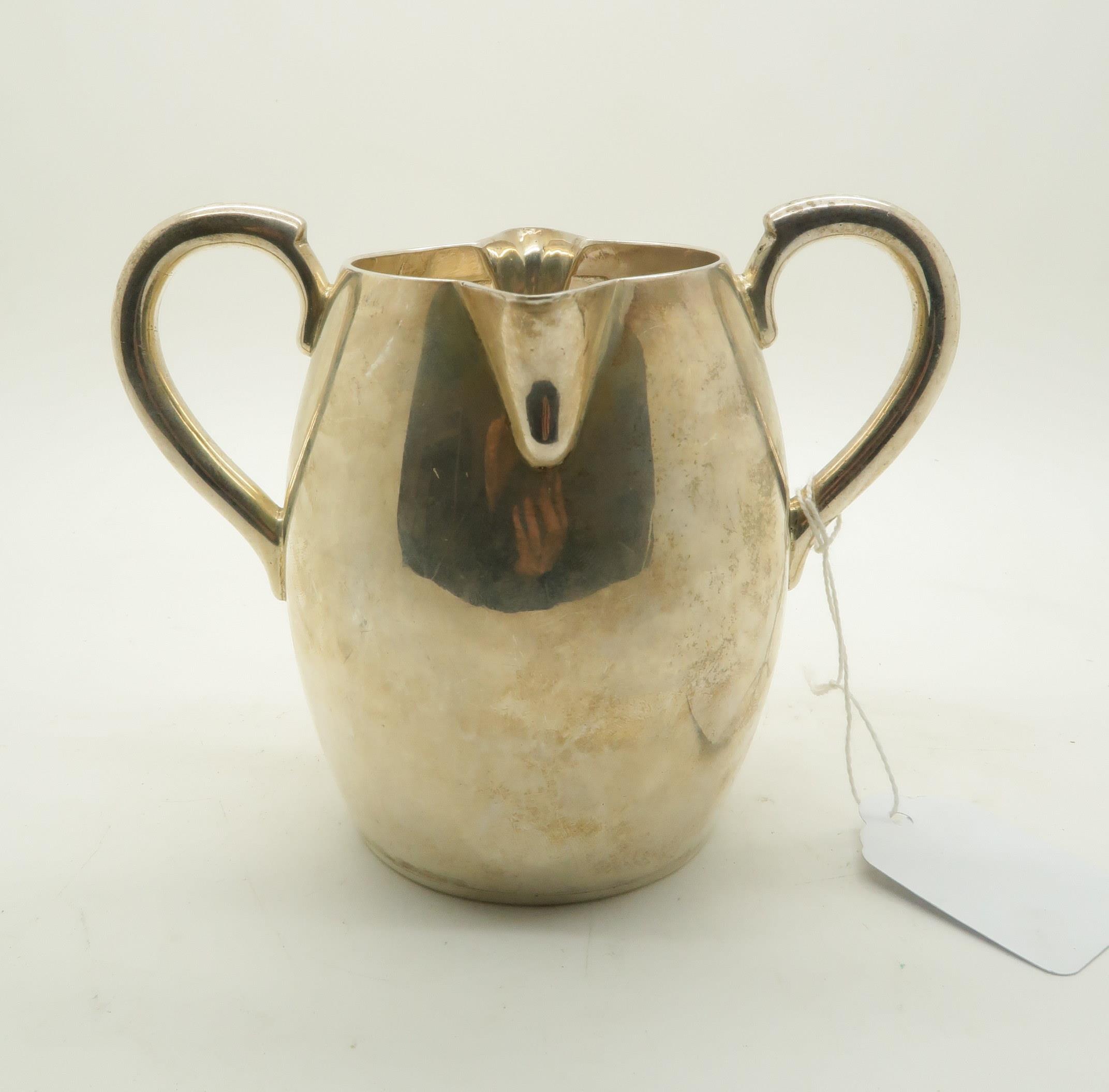 *WITHDRAWN* A George II silver double spout cream jug, with two handles, London 1750, makers