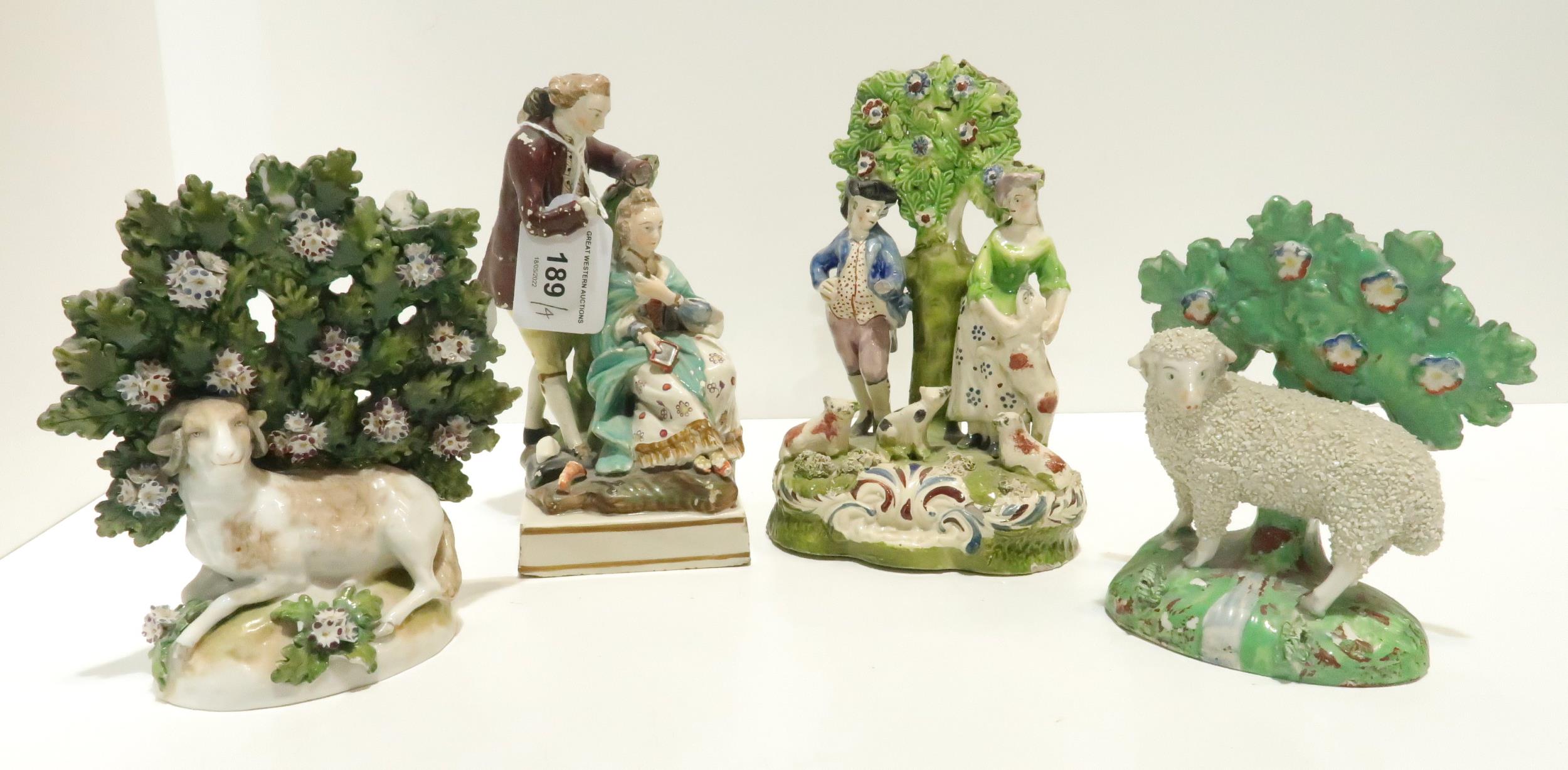 A Staffordshire bocage group of a goat, another of a lamb, a couple with dogs and a pearlware