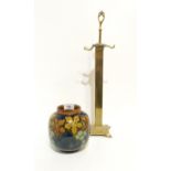 A Royal Doulton vase decorated with grapes, decorated by Ethel Beard and a brass fire poker
